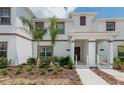 Inviting townhome featuring a well-maintained front yard and covered entry at 4834 Lullaby Ln, Kissimmee, FL 34746