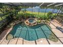 Stunning pool with rock features, spa, lush landscaping, and lake views at 490 Wekiva Preserve Dr, Apopka, FL 32712