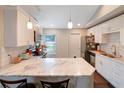 Bright kitchen with white cabinets, stainless steel appliances, and marble countertops at 5032 Timber Ridge Trl, Ocoee, FL 34761