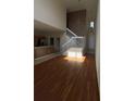 Spacious living room featuring wood floors, staircase, and neutral paint palette at 6024 Chapledale Dr, Orlando, FL 32829
