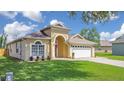 Inviting single-story home with manicured lawn and front-facing two-car garage at 608 Ashwell Ct, Debary, FL 32713