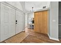 Inviting foyer featuring a sliding wood door leading to the office and a double-door entryway at 641 Lakescape Ct, Orlando, FL 32828