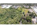 Lush, sprawling landscape featuring a mix of dense trees and open fields with two ponds at 6957 Plymouth Sorrento Rd, Apopka, FL 32712