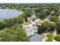 Aerial view of a lakeside community showcasing lush landscaping and a private in-ground pool at 7 Ne Ivanhoe Blvd, Orlando, FL 32804