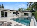 Beautiful backyard pool and patio area with outdoor kitchen, perfect for entertaining and relaxation at 7 Ne Ivanhoe Blvd, Orlando, FL 32804