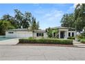 A modern home exterior with a well-manicured lawn and an attached three-car garage at 7 Ne Ivanhoe Blvd, Orlando, FL 32804