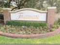 Community sign surrounded by beautiful landscaping at 725 Ashworth Overlook Dr # C, Apopka, FL 32712