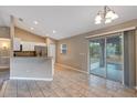 Open dining area with tiled floors, sliding glass doors to the lanai, and natural light at 8 Water Trce, Ocala, FL 34472