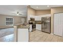 Bright kitchen with white cabinetry, stainless steel appliances, granite countertops, and tiled floors at 8 Water Trce, Ocala, FL 34472