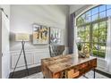Bright home office with large window, wooden desk, and wainscoting, creating a productive space at 811 Sherbourne Cir, Lake Mary, FL 32746