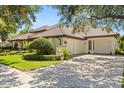 Stunning home featuring a three car garage, pristine landscaping and a classic tile roof at 1010 Juliette Blvd, Mount Dora, FL 32757