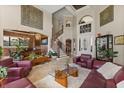 Bright living room boasts soaring ceilings, statement art, and seamless flow to the dining area at 1010 Juliette Blvd, Mount Dora, FL 32757