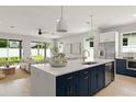 Modern kitchen boasting an island, stainless appliances, and a seamless flow into the living area at 1113 Naples Dr, Orlando, FL 32804