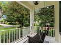 Inviting front porch with a porch swing, perfect for relaxing and enjoying the outdoors at 11721 Camden Park Dr, Windermere, FL 34786