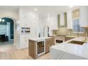 Open kitchen featuring custom cabinets, modern appliances, wine fridge, and gorgeous countertops at 11721 Camden Park Dr, Windermere, FL 34786