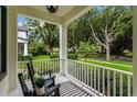 Inviting front porch with rocking chairs and a view of the neighborhood at 11721 Camden Park Dr, Windermere, FL 34786