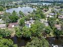 Beautiful aerial view of the home, pool, and landscaping situated on a lake at 120 Springwood Trl, Altamonte Springs, FL 32714