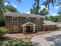 Charming two-story home with brick and siding exterior features a brick walkway and new landscaping at 120 Springwood Trl, Altamonte Springs, FL 32714