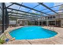 Enjoy the large in-ground screened-in pool with a stone surround, alongside a jacuzzi at 120 Springwood Trl, Altamonte Springs, FL 32714