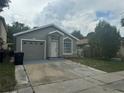 Single-story home with grey exterior paint, a one-car garage, and landscaping at 1241 Cleveland Ave, Apopka, FL 32703