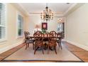 Formal dining room with hardwood floors, a chandelier, and a wooden table with chairs at 1355 Hibiscus Ave, Winter Park, FL 32789