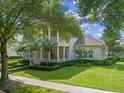 Charming two-story home featuring a double-decker front porch, beautiful landscaping and a manicured lawn at 1438 Stickley Ave, Celebration, FL 34747