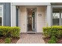 Inviting front entrance with a wreath on the door and well-maintained landscaping at 14390 Orchid Island Dr, Orlando, FL 32827