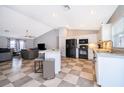 Modern kitchen open to living area, featuring white cabinets and black appliances at 146 Hidden Pointe Ln, Groveland, FL 34736