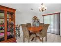 Cozy dining area featuring a wood table, upholstered chairs, and natural lighting at 1588 Alloway Dr, Deltona, FL 32738