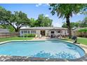 Backyard swimming pool with ample lounge space, a pergola, and well-maintained landscaping at 2020 Geronimo Trl, Maitland, FL 32751