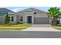 Charming single-story home boasts a lush lawn, landscaped beds, and a two-car garage with brick-paved driveway at 2171 Timber Creek Ln, Clermont, FL 34715