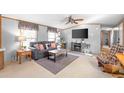 Comfortable living room with ceiling fan, soft carpet, grey sofa, and a flat-screen TV at 238 Lake Dr, Orlando, FL 32835