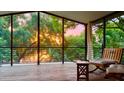 Relaxing screened porch with comfortable seating, perfect for enjoying sunsets amidst lush greenery at 238 Lake Dr, Orlando, FL 32835