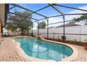 Inviting screened pool area featuring a sparkling pool with a waterfall, perfect for relaxation and outdoor enjoyment at 314 Edgewood Ct, Kissimmee, FL 34759