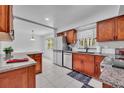 Updated kitchen with granite countertops, stainless steel appliances, and a view into the dining area at 320 Bridle Path, Casselberry, FL 32707
