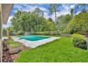 In-ground pool with concrete surround and well-maintained backyard and lawn at 320 Bridle Path, Casselberry, FL 32707