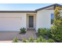 Well-maintained home features a manicured lawn and brick walkway leading to a modern, inviting front door at 3253 Viceroy Ct, Poinciana, FL 34759