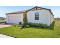 Well-manicured lawn and landscaped front yard enhance this modern single-Gathering home's curb appeal at 3253 Viceroy Ct, Poinciana, FL 34759