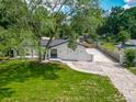 An elevated view of a single-story home showcasing the lawn and driveway at 3325 Horseshoe Dr, Longwood, FL 32779