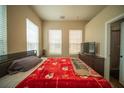 Cozy bedroom with a comfortable bed, natural light from two windows, and a warm, inviting atmosphere at 338 Roberts Family Ln, Winter Springs, FL 32708