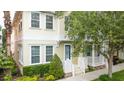 Inviting two-story home with a charming porch, lush landscaping, and a bright, cheerful exterior at 338 Roberts Family Ln, Winter Springs, FL 32708