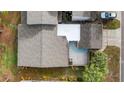 Aerial view of the home showing the backyard patio and landscaping, plus roof and driveway at 411 Meadowood Blvd, Fern Park, FL 32730