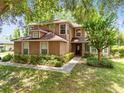 Charming two-story home featuring a manicured lawn and inviting front entrance at 556 Lake Ave, Altamonte Springs, FL 32701