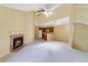 Open living space with a fireplace flowing into a kitchen featuring white appliances and wood cabinets at 6052 Westgate Dr # 204, Orlando, FL 32835