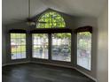 Bright living room featuring a ceiling fan, large windows, grey walls, and wood-look flooring at 652 Roaring Dr # 234, Altamonte Springs, FL 32714