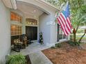 Inviting covered porch with rocking chairs and double-door entry, perfect for relaxing at 809 Palmetto Ter, Oviedo, FL 32765