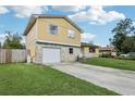 View of the house's front featuring a stone facade and a two-car garage at 8652 Savory Dr, Orlando, FL 32825
