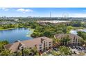 Aerial view of apartments overlooking a lake with the Orlando Eye and skyline in the distance at 8801 Latrec Ave # 8107, Orlando, FL 32819