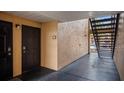 Apartment entrance with dark wood door and black trim plus stairs to upper levels at 8801 Latrec Ave # 8107, Orlando, FL 32819