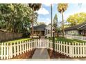 Charming home with a white picket fence, mature trees and meticulously maintained lawn at 911 S Oak Ave, Sanford, FL 32771